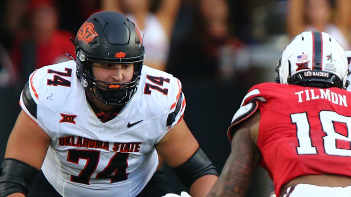 Oklahoma State Cowboys offensive lineman Grant Seagren (74) and offensive lineman Jacob Sanders (75) prepare to block Texas Tech Red Raiders defensive back Terrell Timon (18) in the second half at Jones AT&T Stadium. 