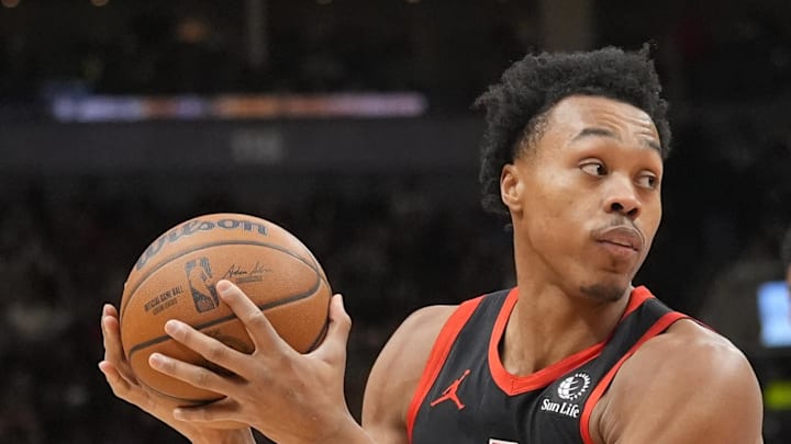 Toronto Raptors guard Scottie Barnes looks for a play as Charlotte Hornets guard LaMelo Ball defends Toronto Raptors guard Scottie Barnes looks for a play as Charlotte Hornets guard LaMelo Ball defends