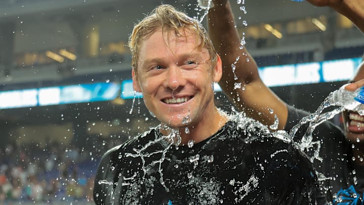 Jul 18, 2025; Miami, Florida, USA; Miami Marlins left fielder Kyle Stowers (28) is doused with water by teammates after hitting a two-run walk-off home run against the Kansas City Royals during the tenth inning at loanDepot Park. Mandatory Credit: Sam Navarro-Imagn Images