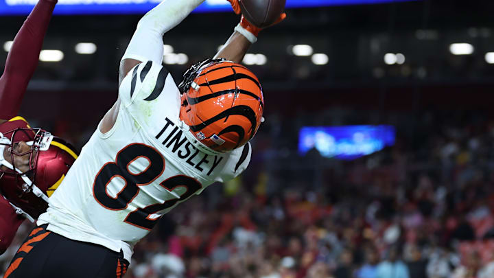 Aug 18, 2025; Landover, Maryland, USA; Cincinnati Bengals wide receiver Mitchell Tinsley (82) catches a touchdown pass over Washington Commanders cornerback Car'lin Vigers (22) during the first half at Northwest Stadium. Mandatory Credit: Amber Searls-Imagn Images