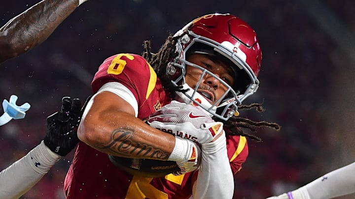 Nov 7, 2025; Los Angeles, California, USA; Southern California Trojans wide receiver Makai Lemon (6) scores a touchdown against Northwestern Wildcats defensive back Josh Fussell (13) during the first half at the Los Angeles Memorial Coliseum. Mandatory Credit: Gary A. Vasquez-Imagn Images Nov 7, 2025; Los Angeles, California, USA; Southern California Trojans wide receiver Makai Lemon (6) scores a touchdown against Northwestern Wildcats defensive back Josh Fussell (13) during the first half at the Los Angeles Memorial Coliseum. Mandatory Credit: Gary A. Vasquez-Imagn Images