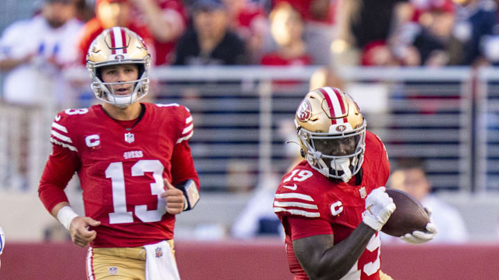 San Francisco 49ers wide receiver Deebo Samuel runs after a pass from quarterback Brock Purdy.