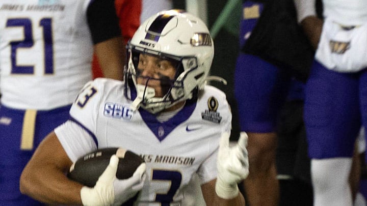 James Madison’s Landon Ellis, right, pulls down a reception during the first quarter ahead of Oregon’s Theran Johnson at Autzen Stadium in Eugene Dec. 20, 2025.