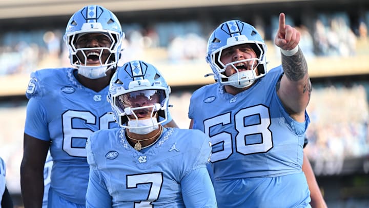 Nov 22, 2025; Chapel Hill, North Carolina, USA; North Carolina Tar Heels quarterback Gio Lopez (7) celebrates after scoring a touchdown during the first half against the Duke Blue Devils  at Kenan Stadium. Mandatory Credit: William Howard-Imagn Images