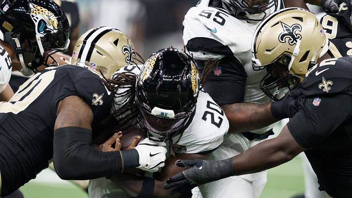 Aug 15, 2026; New Orleans, Louisiana, USA; New Orleans Saints linebacker Kaden Elliss (55) and defensive lineman Jay'viar Suggs (62) tackle Jacksonville Jaguars running back Deejay Dallas (20) during the first quarter at Caesars Superdome. 