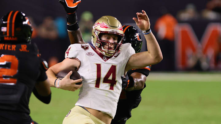 Oct 26, 2024; Miami Gardens, Florida, USA; Florida State Seminoles quarterback Luke Kromenhoek (14) slides after running with the football against the Miami Hurricanes during the third quarter at Hard Rock Stadium. Mandatory Credit: Sam Navarro-Imagn Images