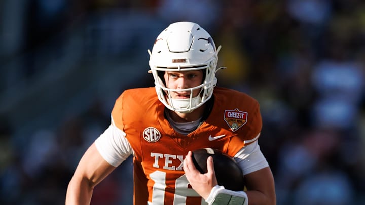 Texas Longhorns quarterback Arch Manning (16) runs with the ball against the Michigan Wolverines during the first half at Camping World Stadium. Mandatory Credit: Matt Pendleton-Imagn Images