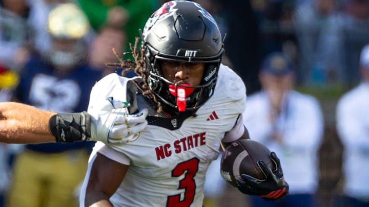 Oct 11, 2025; South Bend, Indiana, USA; NC State Wolfpack running back Hollywood Smothers (3) tries to break a tackle attempt by Notre Dame Fighting Irish linebacker Joshua Burnham (40) during the first half at Notre Dame Stadium. Mandatory Credit: Michael Caterina-Imagn Images Oct 11, 2025; South Bend, Indiana, USA; NC State Wolfpack running back Hollywood Smothers (3) tries to break a tackle attempt by Notre Dame Fighting Irish linebacker Joshua Burnham (40) during the first half at Notre Dame Stadium. Mandatory Credit: Michael Caterina-Imagn Images