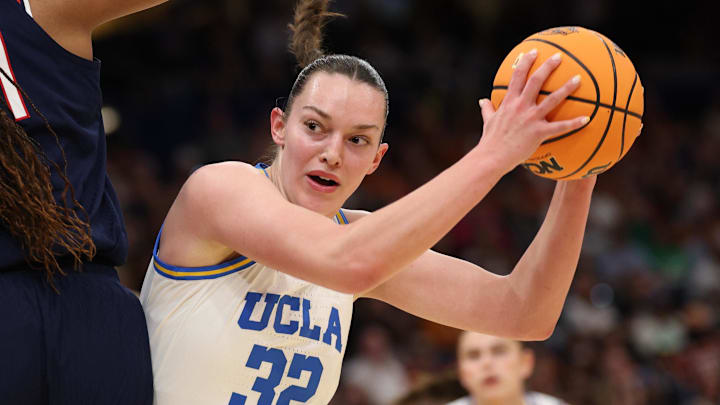 Apr 4, 2025; Tampa, FL, USA; UCLA Bruins forward Angela Dugalic (32) drives against Connecticut Huskies forward Sarah Strong (21) during first quarter in a semifinal of the women's 2025 NCAA tournament at Amalie Arena. Mandatory Credit: Nathan Ray Seebeck-Imagn Images Apr 4, 2025; Tampa, FL, USA; UCLA Bruins forward Angela Dugalic (32) drives against Connecticut Huskies forward Sarah Strong (21) during first quarter in a semifinal of the women's 2025 NCAA tournament at Amalie Arena. Mandatory Credit: Nathan Ray Seebeck-Imagn Images