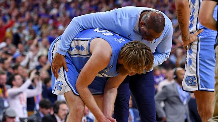 Apr 4, 2022; New Orleans, LA, USA; North Carolina Tar Heels head coach Hubert Davis hugs forward Brady Manek (45) after losing the 2022 NCAA men's basketball tournament Final Four championship game against the Kansas Jayhawks at Caesars Superdome. Mandatory Credit: Bob Donnan-Imagn Images Apr 4, 2022; New Orleans, LA, USA; North Carolina Tar Heels head coach Hubert Davis hugs forward Brady Manek (45) after losing the 2022 NCAA men's basketball tournament Final Four championship game against the Kansas Jayhawks at Caesars Superdome. Mandatory Credit: Bob Donnan-Imagn Images