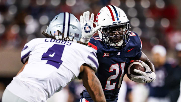 Sep 12, 2025; Tucson, Arizona, USA; Arizona Wildcats running back Ismail Mahdi (21) runs the ball while Kansas State Wildcats safety Daniel Cobbs (4) defends during the fourth quarter at Arizona Stadium. Mandatory Credit: Aryanna Frank-Imagn Images
