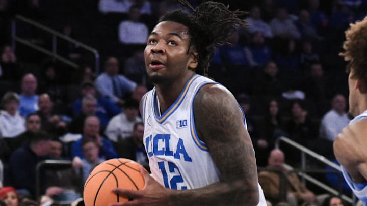 Dec 21, 2024; New York, NY, USA; UCLA Bruins guard Sebastian Mack (12) drives to the basket while being defended by North Carolina Tar Heels guard Seth Trimble (7) during the first half at Madison Square Garden. Mandatory Credit: John Jones-Imagn Images Dec 21, 2024; New York, NY, USA; UCLA Bruins guard Sebastian Mack (12) drives to the basket while being defended by North Carolina Tar Heels guard Seth Trimble (7) during the first half at Madison Square Garden. Mandatory Credit: John Jones-Imagn Images