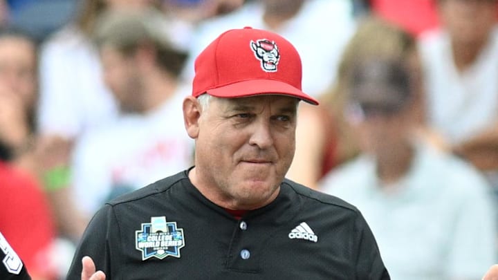Jun 15, 2024; Omaha, NE, USA;  NC State Wolfpack head coach Elliott Avent discusses a balk call with an umpire in the game against the Kentucky Wildcats during the eighth inning at Charles Schwab Field Omaha. Mandatory Credit: Steven Branscombe-Imagn Images