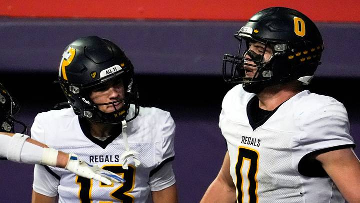 Iowa City Regina’s Tate Wallace (0) celebrates with teammates after scoring a touchdown Nov. 20, 2025 during the Class 1A state football championship against the West Lyon Wildcats at the UNI-Dome in Cedar Falls, Iowa.