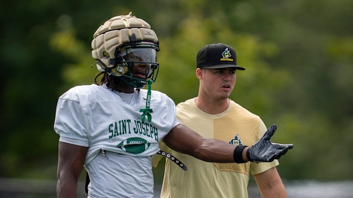 St. Joseph’s Tahj Gray (17) speaks with his coach during a combined practice and scrimmage between St. Joseph Regional and Delbarton at Delbarton School in Morristown on Monday, Aug. 18, 2025.