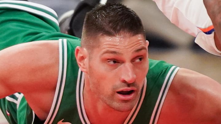 Apr 9, 2026; New York, New York, USA; New York Knicks center Mitchell Robinson (23) wins a loose ball from Boston Celtics center Nikola Vucevic (4) during the first half at Madison Square Garden. Mandatory Credit: Lucas Boland-Imagn Images