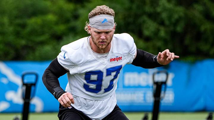 Detroit Lions defensive end Aidan Hutchinson (97) walks on to the field before practice during minicamp Detroit Lions defensive end Aidan Hutchinson (97) walks on to the field before practice during minicamp