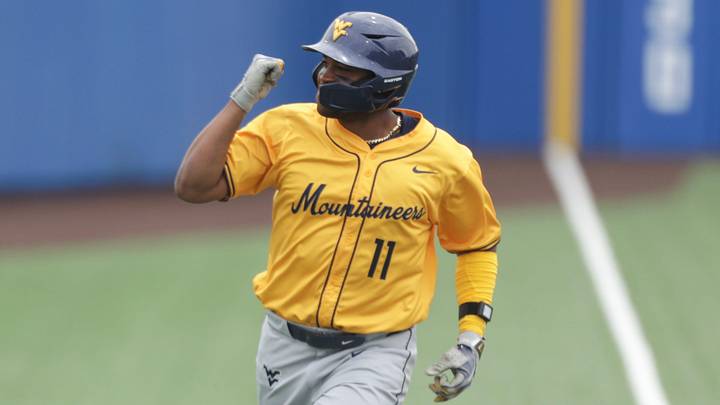 West Virginia Mountaineers graduate Sean Smith (11) pumps his first after hitting a home run against Kansas Jayhawks during the game inside Hoglund Ballpark on May 10, 2026.