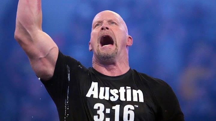 Apr 2, 2022; Arlington, TX, USA; Stone Cold Steve Austin celebrates with beer after defeating Kevin Owens (not pictured) at WrestleMania at AT&T Stadium. Mandatory Credit: Joe Camporeale-Imagn Images