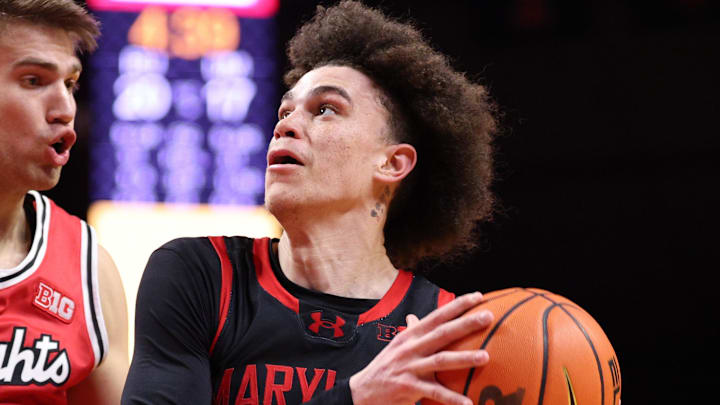Feb 15, 2026; Piscataway, New Jersey, USA; Maryland Terrapins guard Darius Adams (1) goes to the basket against Rutgers Scarlet Knights guard Harun Zrno (13) during the first half at Jersey Mike's Arena. Mandatory Credit: Vincent Carchietta-Imagn Images