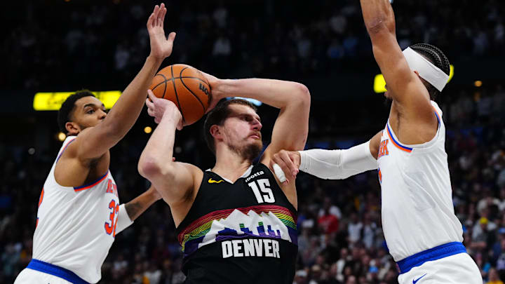 Mar 6, 2026; Denver, Colorado, USA; New York Knicks center Karl-Anthony Towns (32) and New York Knicks guard Josh Hart (3) defend Denver Nuggets center Nikola Jokic (15) in the first quarter at Ball Arena.