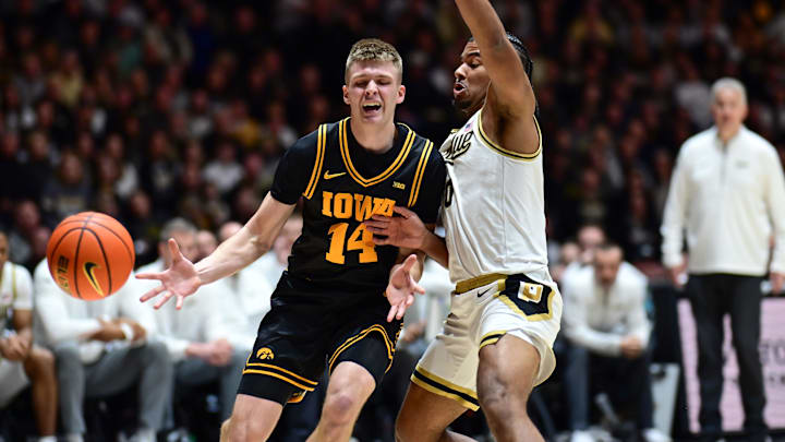 Jan 14, 2026; West Lafayette, Indiana, USA; Iowa Hawkeyes guard Bennett Stirtz (14) loses control of the ball in front of Purdue Boilermakers guard C.J Cox (0) during the first half at Mackey Arena. Mandatory Credit: Marc Lebryk-Imagn Images