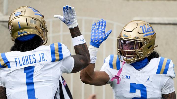 Oct 11, 2025; East Lansing, Michigan, USA; UCLA Bruins wide receiver Titus Mokiao-Atimalala (2) celebrates a touchdown with wide receiver Rico Flores Jr. (1) in the second quarter at Spartan Stadium. Mandatory Credit: Brendan Mullin-Imagn Images Oct 11, 2025; East Lansing, Michigan, USA; UCLA Bruins wide receiver Titus Mokiao-Atimalala (2) celebrates a touchdown with wide receiver Rico Flores Jr. (1) in the second quarter at Spartan Stadium. Mandatory Credit: Brendan Mullin-Imagn Images