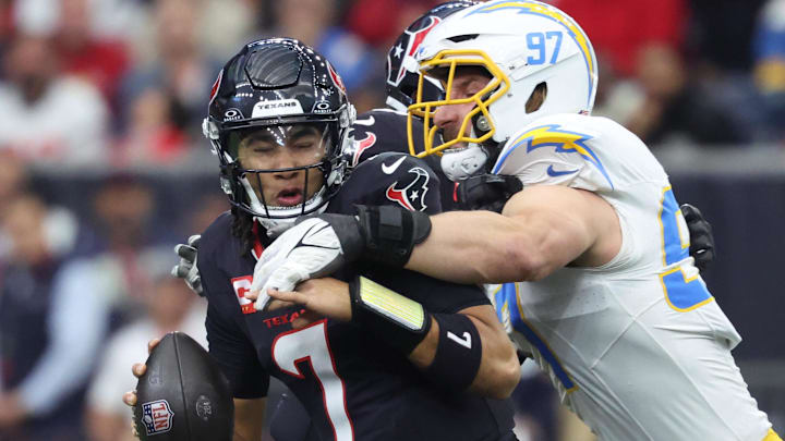 Jan 11, 2025; Houston, Texas, USA; Los Angeles Chargers outside linebacker Joey Bosa (97) sacks Houston Texans quarterback C.J. Stroud (7) during the first quarter in an AFC wild card game at NRG Stadium. Mandatory Credit: Troy Taormina-Imagn Images
