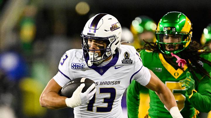 Dec 20, 2025; Eugene, OR, USA; James Madison Dukes wide receiver Landon Ellis (13) runs after making a catch as Oregon Ducks defensive back Theran Johnson (5) defends during the second quarter at Autzen Stadium. Mandatory Credit: Troy Wayrynen-Imagn Images