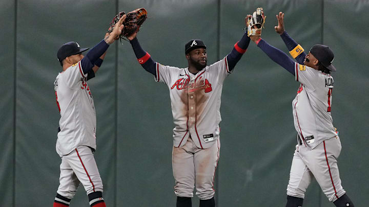 Aug 25, 2023; San Francisco, California, USA; Atlanta Braves center fielder Michael Harris II (center) celebrates with left fielder Eddie Rosario (left) and right fielder Ronald Acuna Jr. (right) after defeating the San Francisco Giants at Oracle Park. Mandatory Credit: Darren Yamashita-Imagn Images