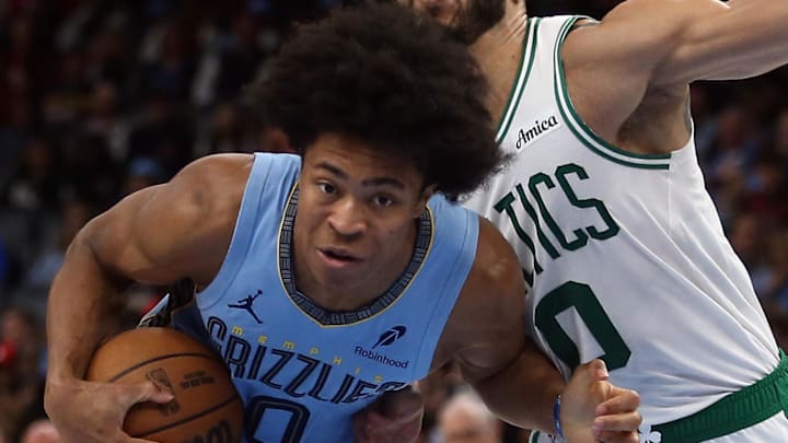Mar 31, 2025; Memphis, Tennessee, USA; Memphis Grizzlies forward Jaylen Wells (0) drives to the basket as Boston Celtics forward Jayson Tatum (0) defends during the third quarter at FedExForum. Mandatory Credit: Petre Thomas-Imagn Images