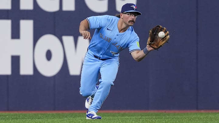Mar 31, 2025; Toronto, Ontario, CAN; Toronto Blue Jays outfielder Davis Schneider (36) fields the ball against the Washington Nationals during the seventh inning at Rogers Centre. 