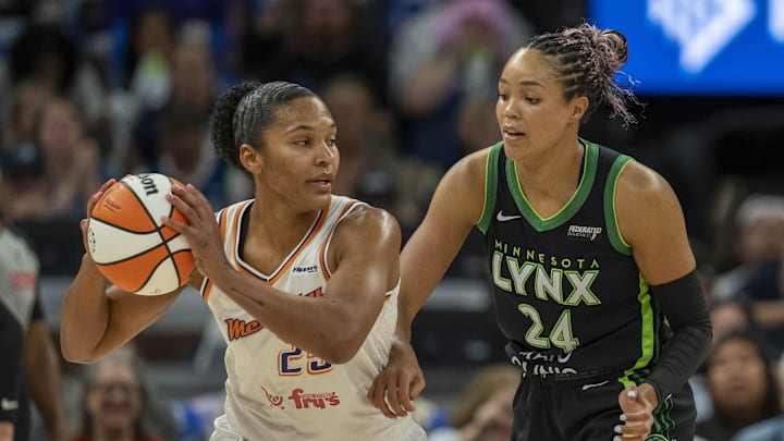 Sep 21, 2025; Minneapolis, Minnesota, USA; Phoenix Mercury forward Alyssa Thomas (25) holds the ball as Minnesota Lynx forward Napheesa Collier (24) plays defense in the first half during game one of the second round for the 2025 WNBA Playoffs at Target Center. Mandatory Credit: Jesse Johnson-Imagn Images