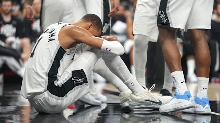 Apr 21, 2026; San Antonio, Texas, USA; San Antonio Spurs forward Victor Wembanyama (1) reacts after falling to the ground during the first half of Game 2 of the first round of the 2026 NBA Playoffs against the Portland Trail Blazers at Frost Bank Center.