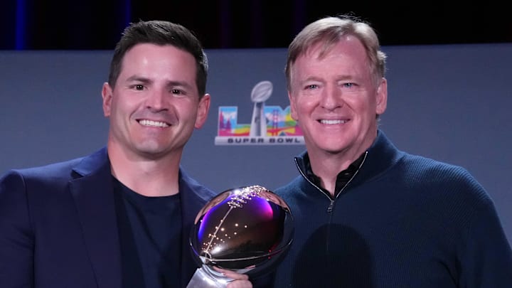 Seattle Seahawks head coach Mike MacDonald and NFL Commissioner Roger Goodell pose with the Vince Lombardi trophy.