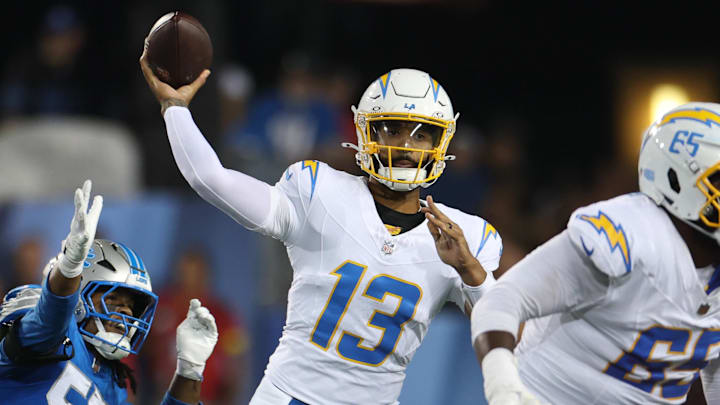 Jul 31, 2025; Canton, Ohio, USA; Los Angeles Chargers quarterback DJ Uiagalelei (13) throws against Detroit Lions defensive end Nate Lynn (57) in the fourth quarter at Tom Benson Hall of Fame Stadium. Mandatory Credit: Scott Galvin-Imagn Images