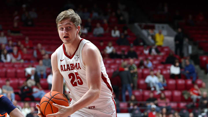 Dec 7, 2025; Tuscaloosa, Alabama, USA; Alabama Crimson Tide's Jacob Martin (25) drives to the basket against UTSA Roadrunners guard Dorian Hayes (0) during the second half at Coleman Coliseum. Mandatory Credit: David Leong-Imagn Images