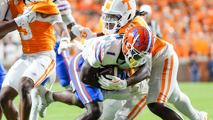 Tennessee defensive lineman Dominic Bailey (90) tackles Florida running back Montrell Johnson Jr. (1) during a SEC conference game between Tennessee and Florida in Neyland Stadium on Saturday, Oct. 12, 2024.