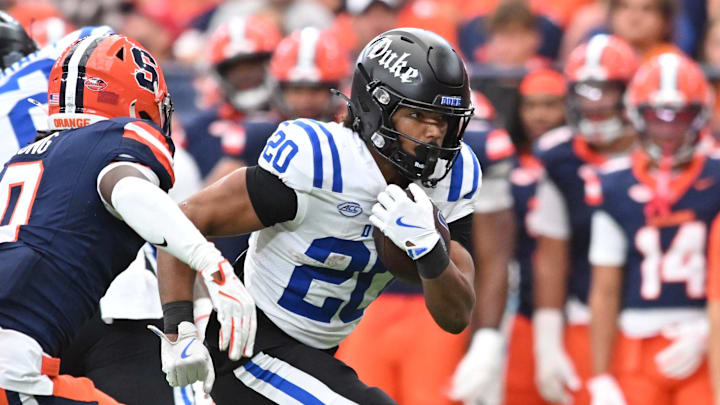 Sep 27, 2025; Syracuse, New York, USA; Duke Blue Devils running back Nate Sheppard (20) tries to run past Syracuse Orange defensive back Braheem Long Jr. (0) in the third quarter at the JMA Wireless Dome. Mandatory Credit: Mark Konezny-Imagn Images
