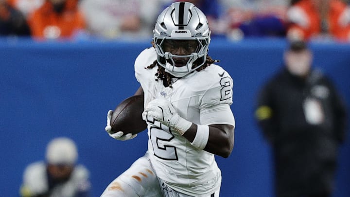 Nov 6, 2025; Denver, Colorado, USA; Las Vegas Raiders running back Ashton Jeanty (2) rushes the ball against the Denver Broncos during the first half at Empower Field at Mile High. Mandatory Credit: Isaiah J. Downing-Imagn Images