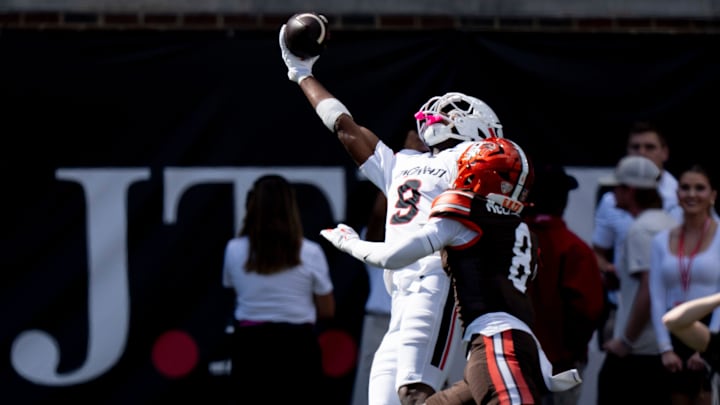 Cincinnati Bearcats wide receiver Jeff Caldwell (9) catches a pass as Bowling Green Falcons cornerback Jalen McClendon (8) defends in the second quarter of the NCAA football game between the Cincinnati Bearcats and Bowling Green Falcons at Nippert Stadium in Cincinnati on Sept. 6, 2025.