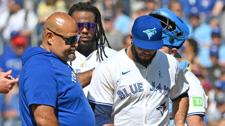 Jun 16, 2024; Toronto, Ontario, CAN;  Toronto Blue Jays relief pitcher Yimi Garcia (93) is relieved by Toronto Blue Jays manager John Schneider (14) in the ninth inning against the Cleveland Guardians at Rogers Centre. Mandatory Credit: Dan Hamilton-Imagn Images