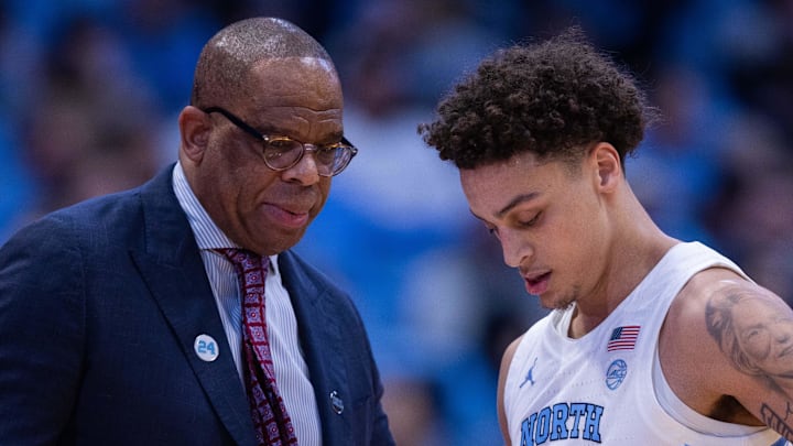 Dec 22, 2025; Chapel Hill, North Carolina, USA; North Carolina Tar Heels head coach Hubert Davis talks with guard Kyan Evans (0) during the first half against the East Carolina Pirates at Dean E. Smith Center. Mandatory Credit: Scott Kinser-Imagn Images