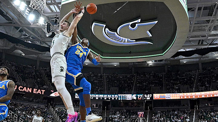 Feb 17, 2026; East Lansing, Michigan, USA; Michigan State Spartans center Carson Cooper (15) draws a flagrant foul call against UCLA Bruins center Steven Jamerson II (24) during the second half at Jack Breslin Student Events Center. Mandatory Credit: Dale Young-Imagn Images