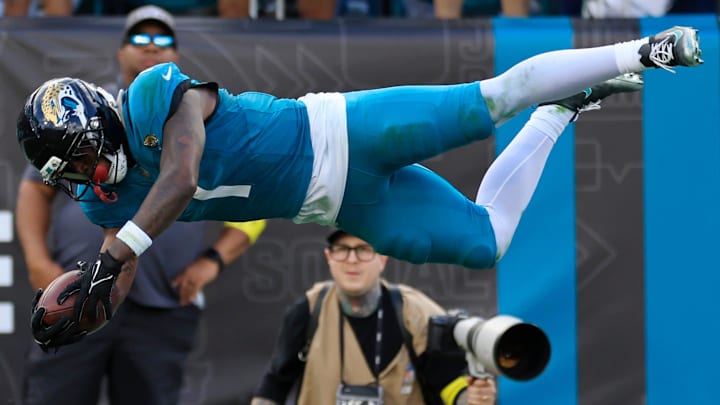 Jacksonville Jaguars running back Travis Etienne Jr. (1) leaps to score a rushing touchdown during the fourth quarter of an NFL football matchup at EverBank Stadium, Sunday, Dec. 14, 2025, in Jacksonville, Fla. The Jaguars defeated the Jets 48-20.