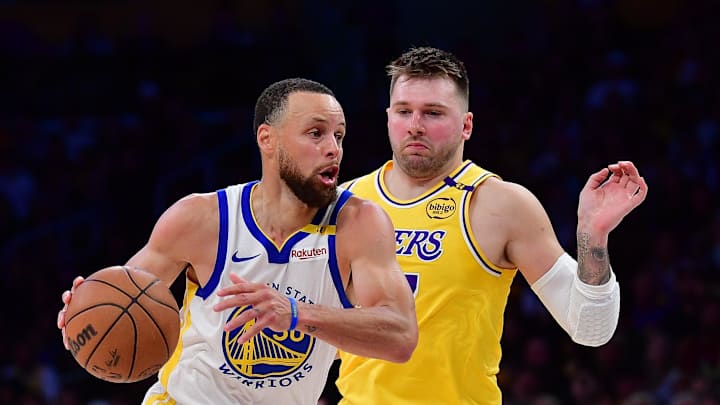 Apr 3, 2025; Los Angeles, California, USA; Golden State Warriors guard Stephen Curry (30) moves to the basket against Los Angeles Lakers guard Luka Doncic (77) during the second half at Crypto.com Arena. Mandatory Credit: Gary A. Vasquez-Imagn Images
