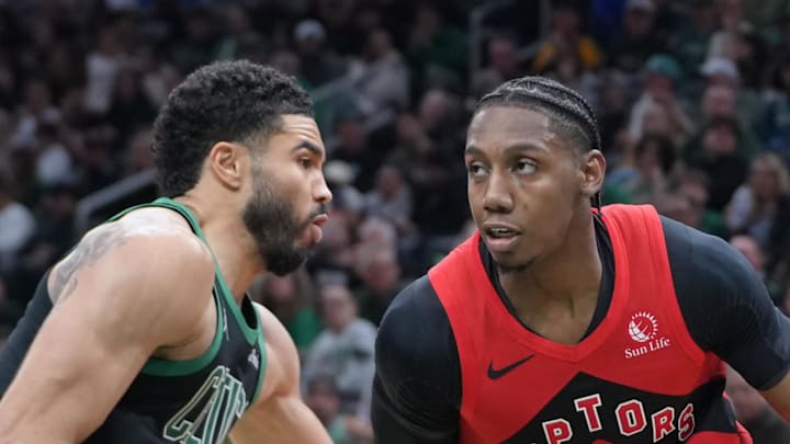 Toronto Raptors forward RJ Barrett dribbles the ball against Boston Celtics forward Jayson Tatum.