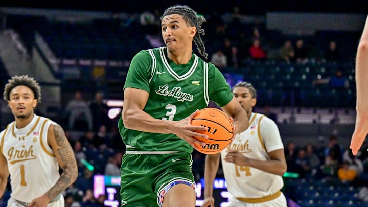 Dec 22, 2024; South Bend, Indiana, USA; Le Moyne Dolphins forward Dwayne Koroma (3) drives to the basket as Notre Dame Fighting Irish forward Tae Davis (7) defends in the second half at the Purcell Pavilion. Mandatory Credit: Matt Cashore-Imagn Images Dec 22, 2024; South Bend, Indiana, USA; Le Moyne Dolphins forward Dwayne Koroma (3) drives to the basket as Notre Dame Fighting Irish forward Tae Davis (7) defends in the second half at the Purcell Pavilion. Mandatory Credit: Matt Cashore-Imagn Images