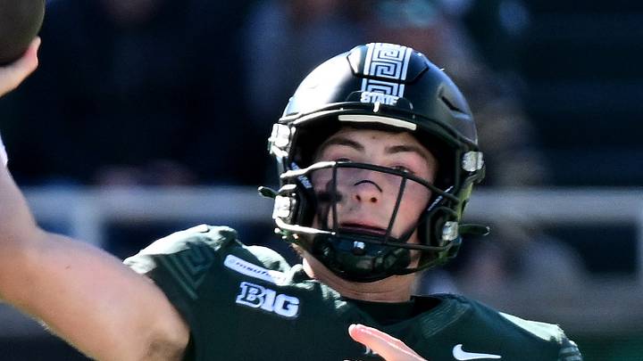 Oct 17, 2026; East Lansing, Michigan, USA;  Michigan State Spartans quarterback Alessio Milivojevic (11) leaps and throws against the Northwestern Wildcats during the first quarter at Spartan Stadium.  Mandatory Credit: Dale Young-Imagn Images