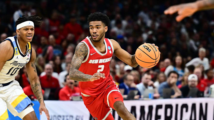 Mar 21, 2025; Cleveland, OH, USA; New Mexico Lobos guard Donovan Dent (2) dribbles defended by Marquette Golden Eagles forward Damarius Owens (10) in the first half during the NCAA Tournament First Round at Rocket Arena. Mandatory Credit: Ken Blaze-Imagn Images